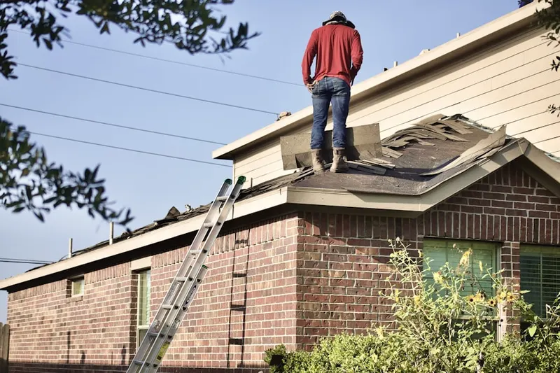 Professional roofer working on a residential roof in Sunrise Golf Village East